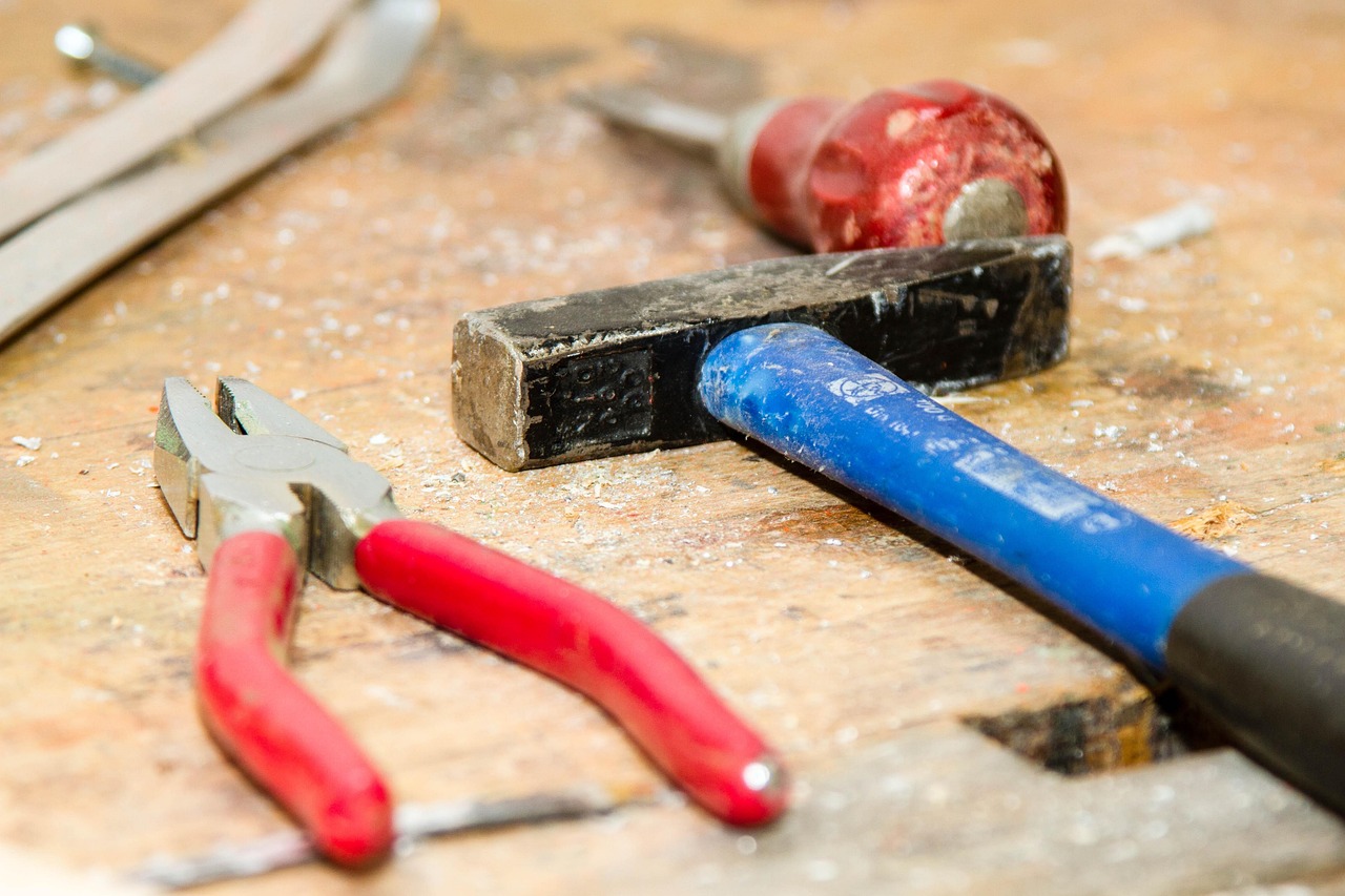 A set of hand tools laid out on a workbench